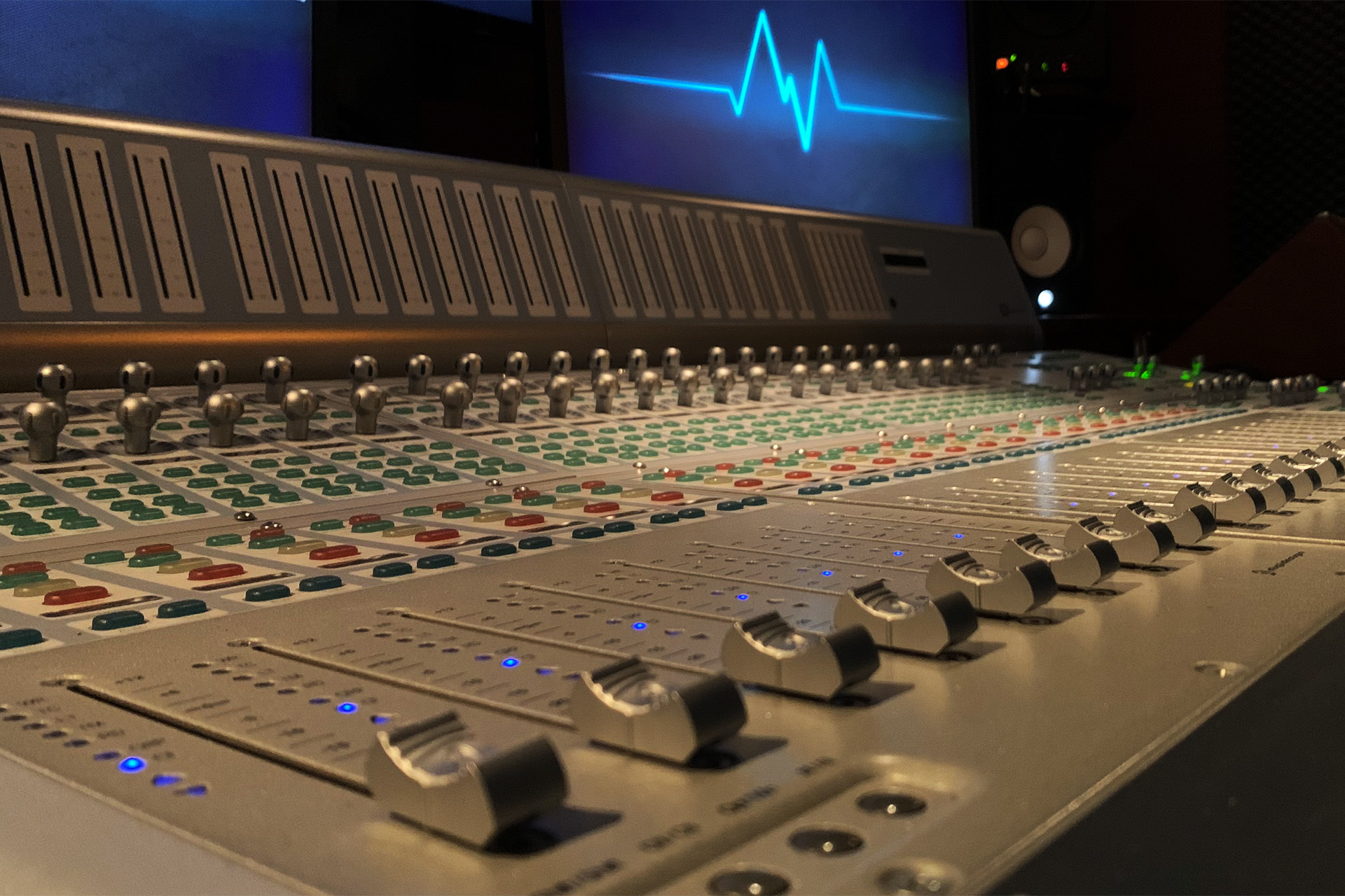 DJ facing a crowd at his deck. Photo with a purple hue